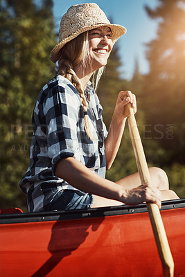 Buy stock photo Shot of an attractive young woman spending a day kayaking on the lake