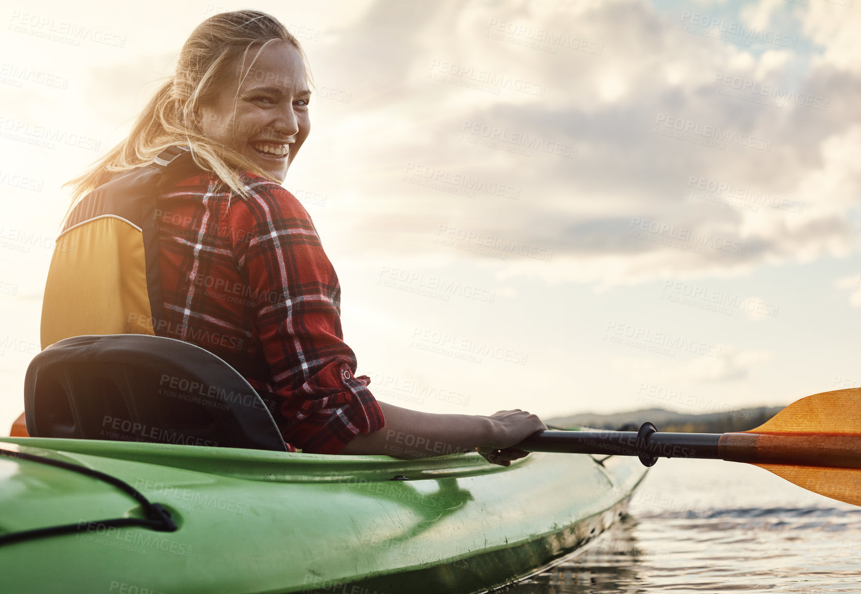 Buy stock photo Shot of an attractive young woman out for canoe ride on the lake