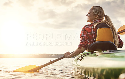 Buy stock photo Shot of an attractive young woman out for canoe ride on the lake