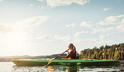 Buy stock photo Shot of an attractive young woman out for canoe ride on the lake