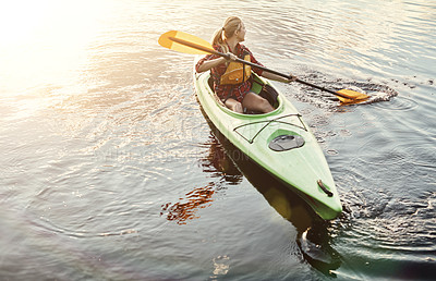 Buy stock photo Shot of an attractive young woman out for canoe ride on the lake