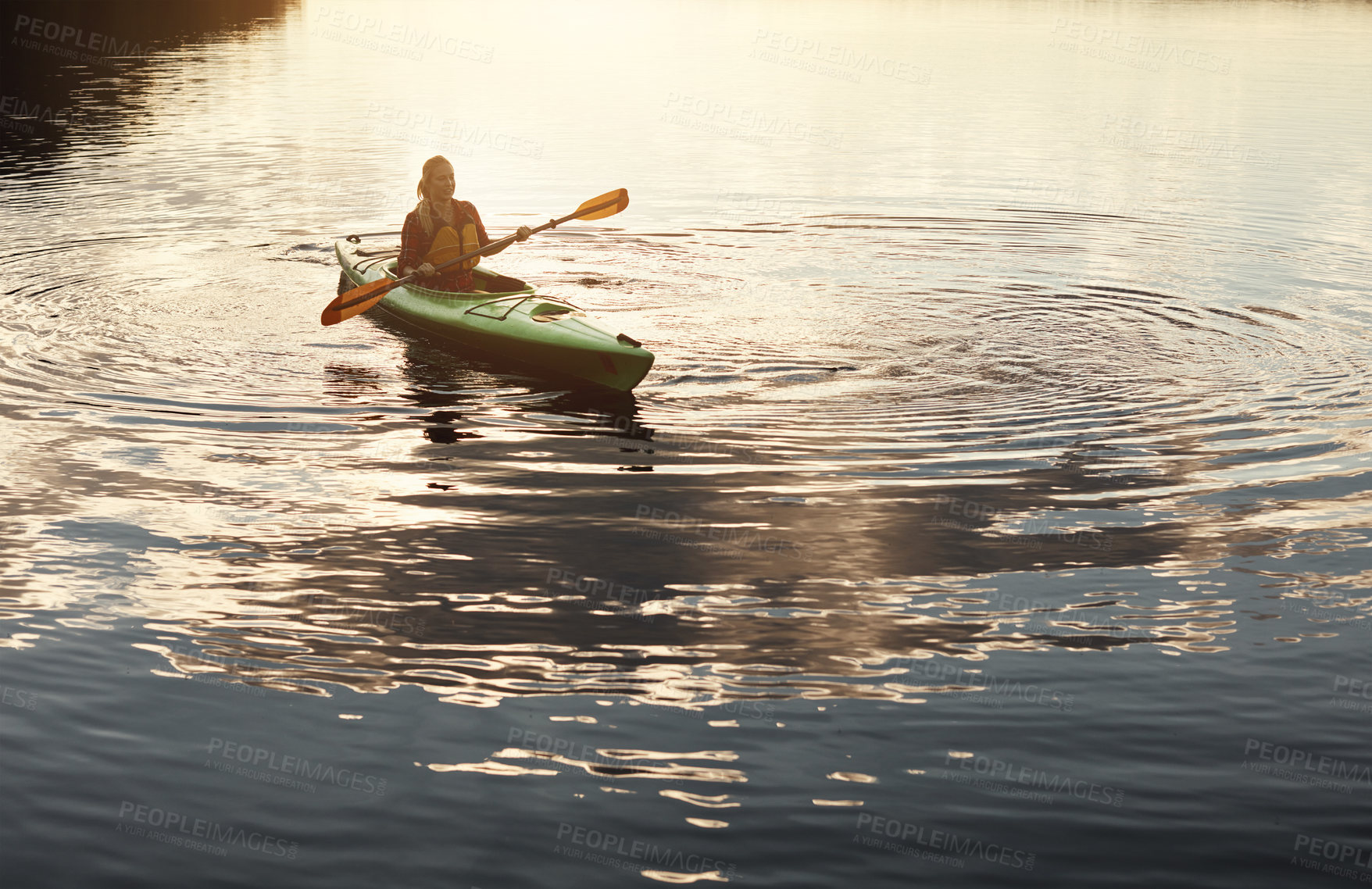 Buy stock photo Shot of an attractive young woman out for canoe ride on the lake