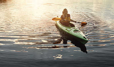 Buy stock photo Shot of an attractive young woman out for canoe ride on the lake