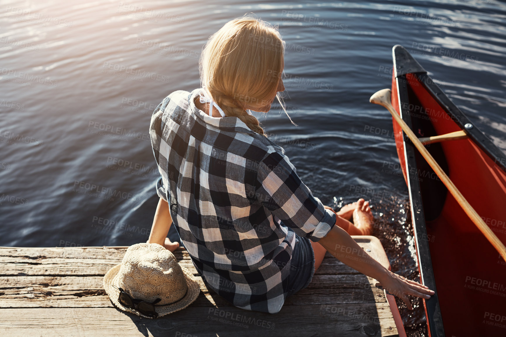 Buy stock photo High angle shot of an attractive young woman spending a day relaxing by the lake