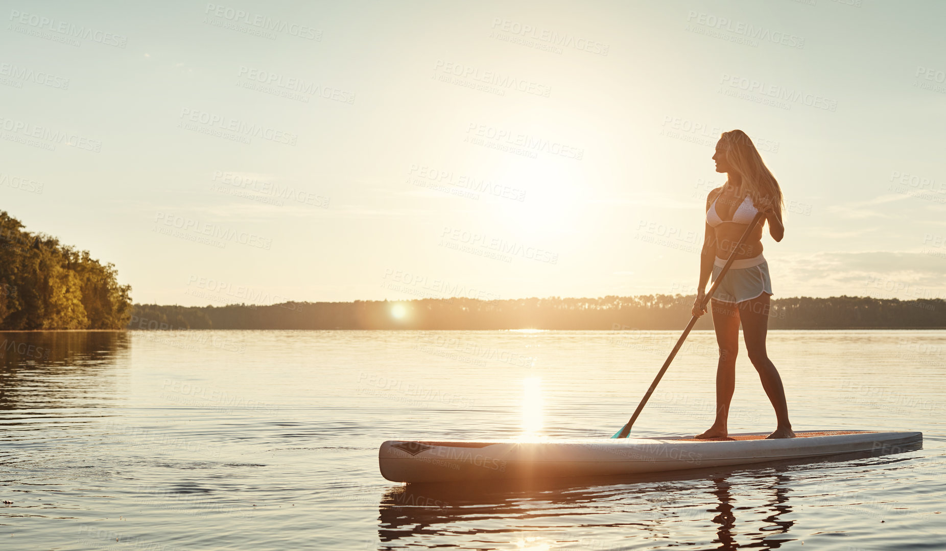 Buy stock photo River, sunset and woman on paddle board with sunshine, water sport and vacation on lake for tourism. Exercise, summer or holiday in Florida for female person, swimsuit or travel fitness for adventure