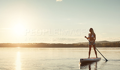 Buy stock photo River, sunset and woman on paddle board with sunshine, water sport and vacation on lake for tourism. Exercise, summer or holiday in Germany for female person, swimsuit or travel fitness for adventure