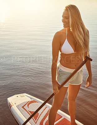 Buy stock photo Lake, smile and woman on paddle board for balance, water sport and vacation on river for tourism. Sunset, summer or holiday in Germany for female person, swimsuit or travel exercise for adventure