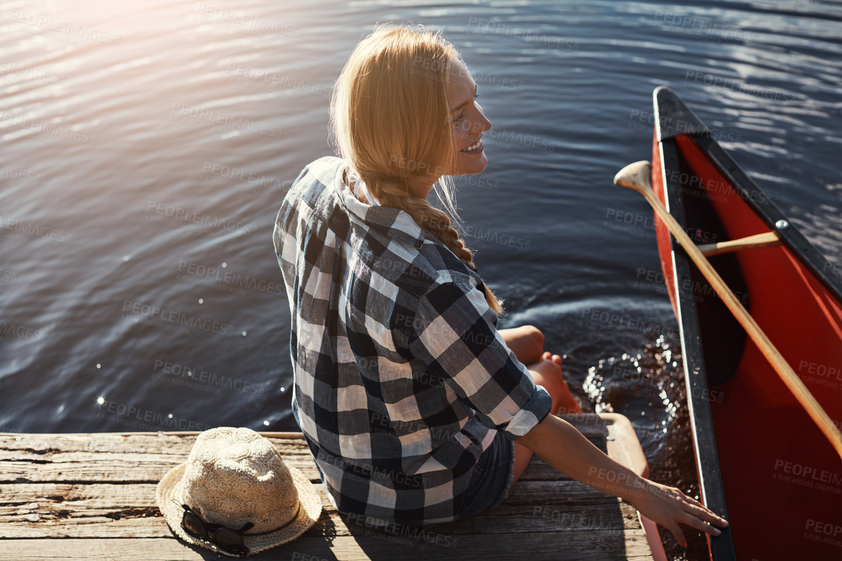 Buy stock photo High angle shot of an attractive young woman spending a day relaxing by the lake