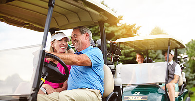 Buy stock photo Shot of an affectionate mature couple spending a day on the golf course