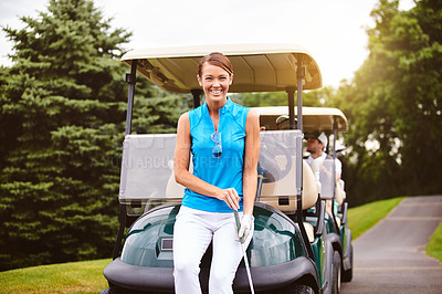 Buy stock photo Cropped portrait of an attractive young woman leaning against a golf cart on a golf course
