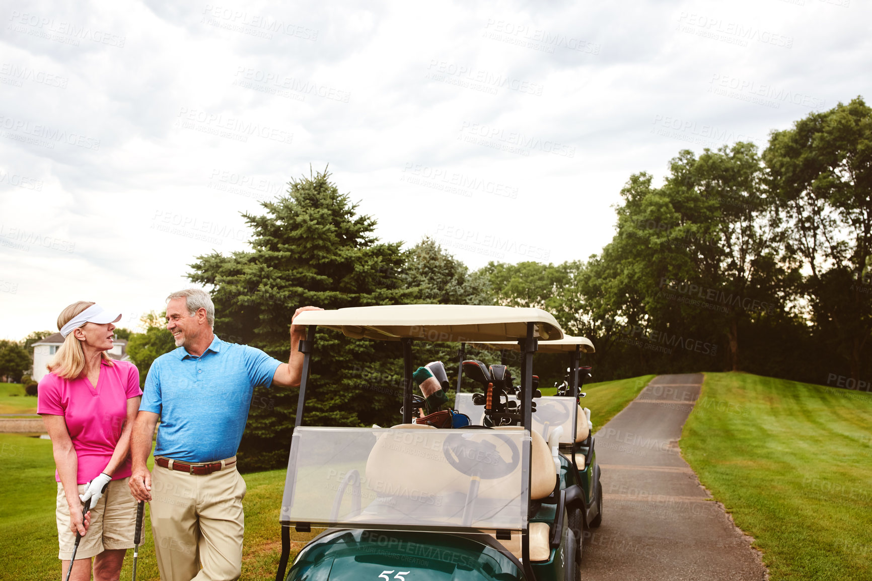 Buy stock photo Shot of an affectionate mature couple spending a day on the golf course