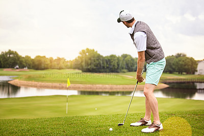 Buy stock photo Full length shot of a handsome young man playing a round of golf on a golf course