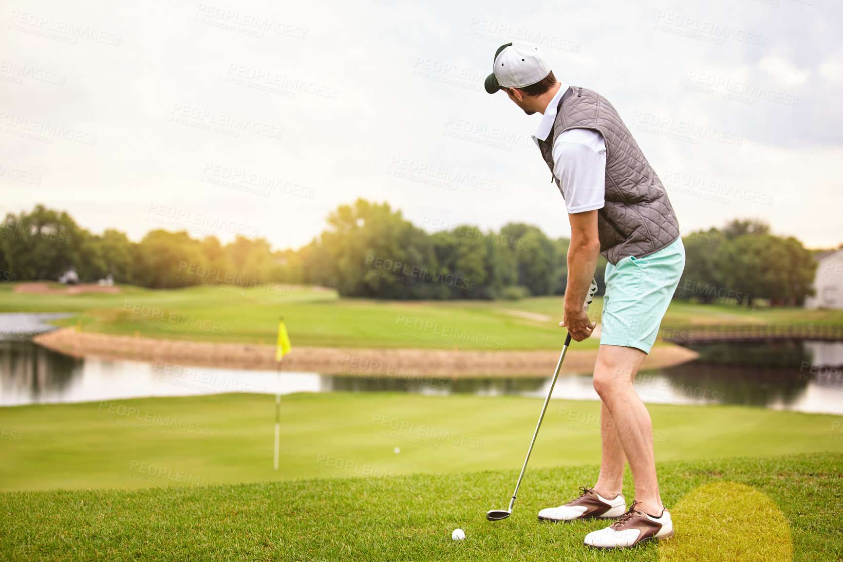 Buy stock photo Full length shot of a handsome young man playing a round of golf on a golf course