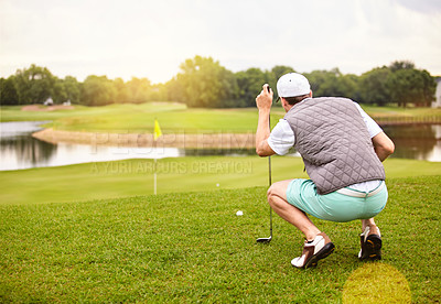 Buy stock photo Full length shot of a handsome young man playing a round of golf on a golf course