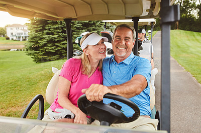 Buy stock photo Shot of an affectionate mature couple spending a day on the golf course