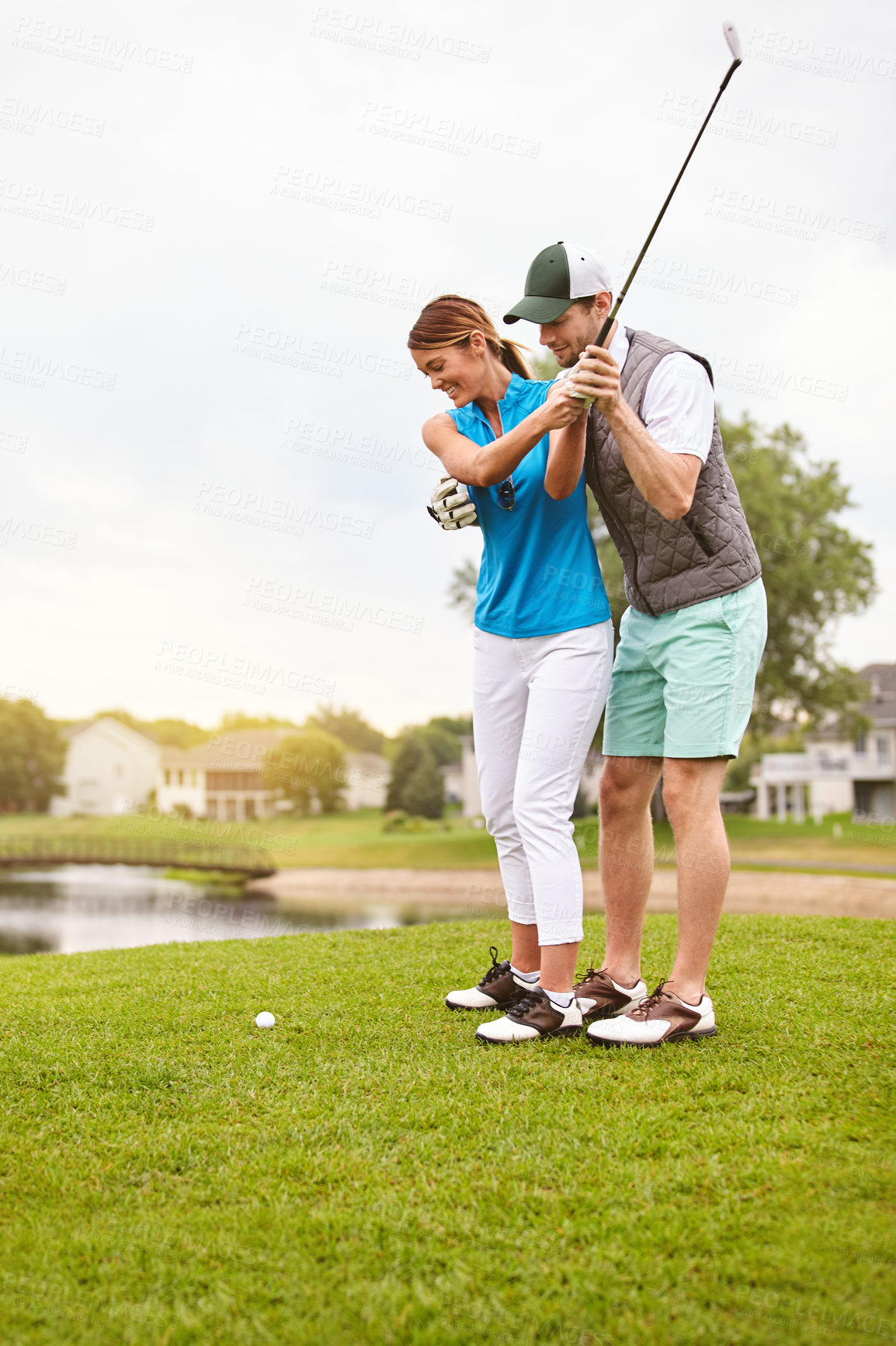 Buy stock photo Couple, help and happy at golf course with swing on vacation, space and guide for game in summer. People, partner and golfer on getaway at country club with sports gear, ball or support on holiday