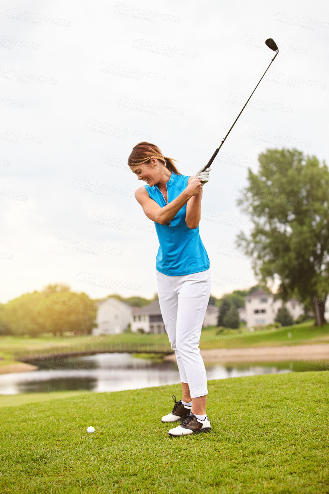 Buy stock photo Full length shot of an attractive young woman playing a round of golf on a golf course