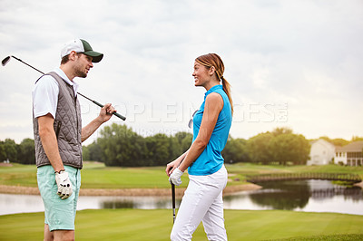 Buy stock photo Shot of an affectionate young couple spending a day on the golf course