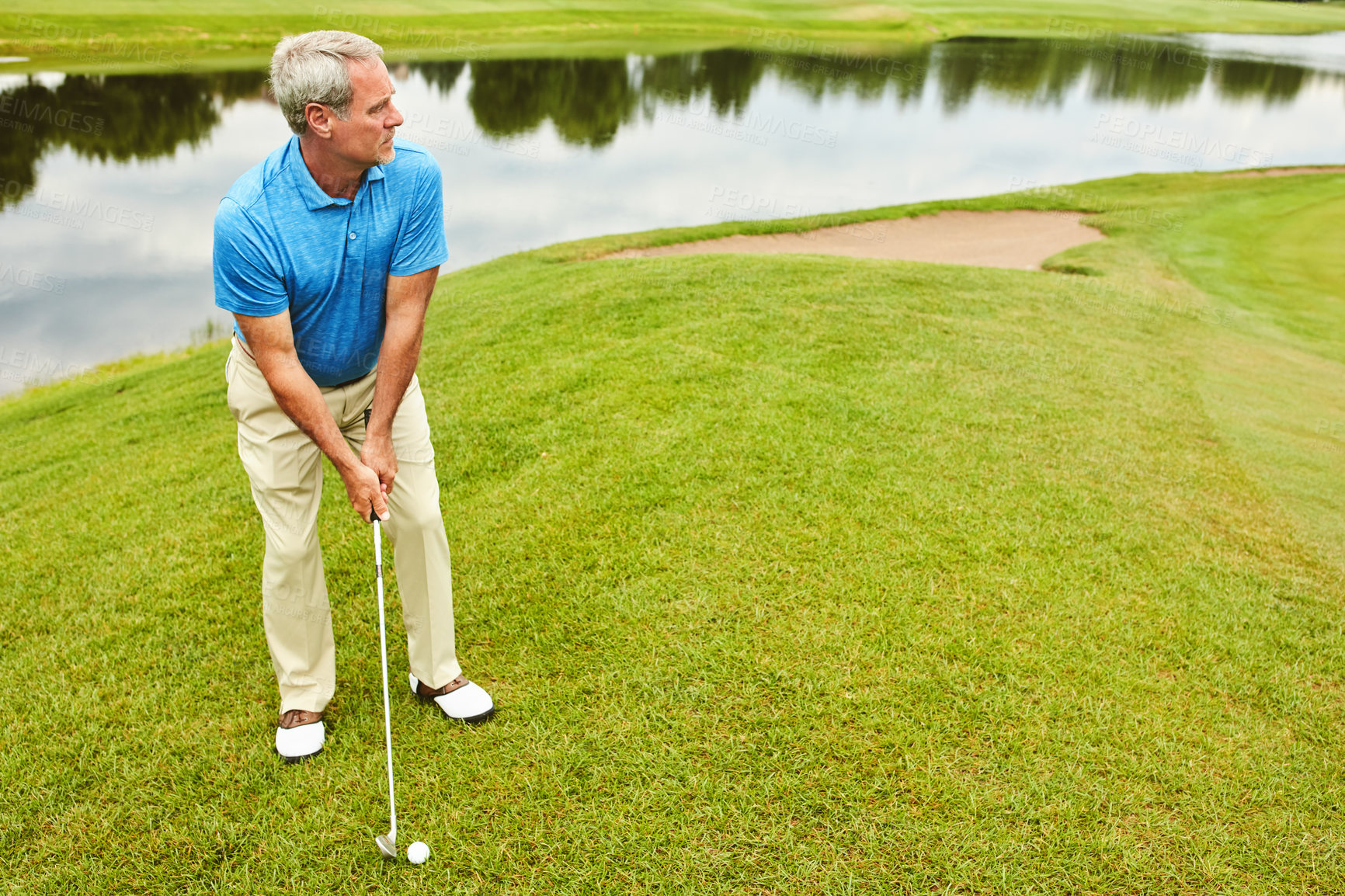 Buy stock photo Mature, man and stroke on grass by golf course with club for mental sport, skill and precision or training for tournament. Male golfer, lake and thoughts for game plan, shot strategy and exercise.