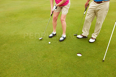 Buy stock photo Outdoor, golf club and legs on green for tee off in team as members in course for health, wellness or fitness. People, putter and hole for sports, exercise or training as athlete in challenge or game