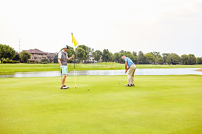 Buy stock photo Men, golf course and fitness on green for tee off in morning as members in club for health, wellness or business. Male people, putter and hole for sports, exercise or meeting as partner in company