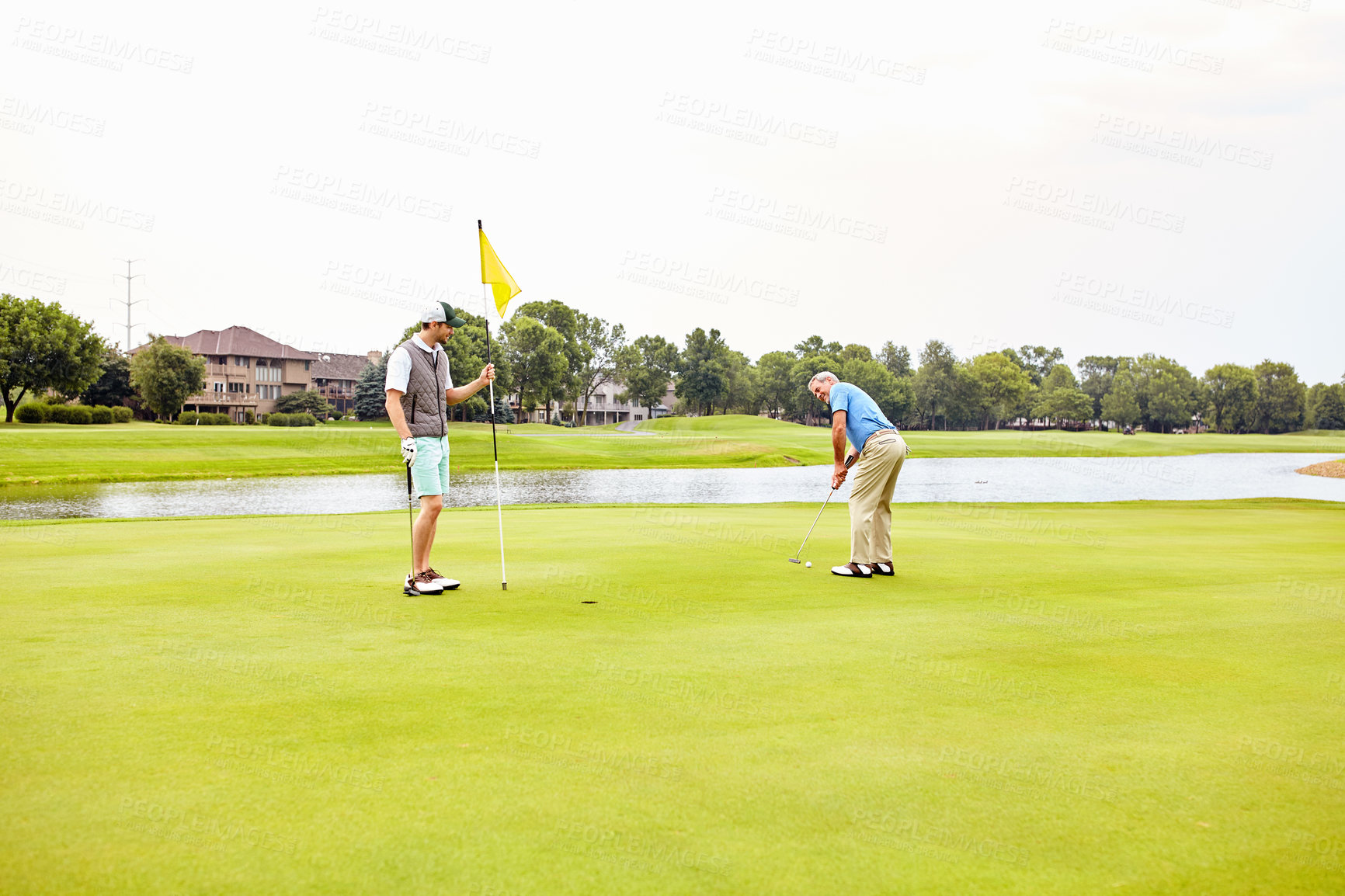 Buy stock photo Men, golf course and fitness on green for tee off in morning as members in club for health, wellness or business. Male people, putter and hole for sports, exercise or meeting as partner in company