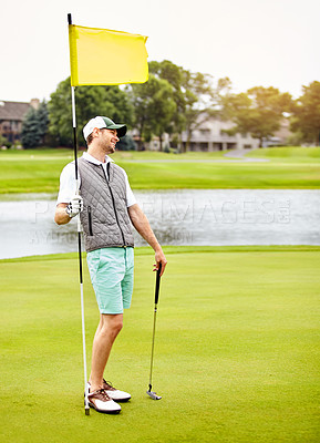 Buy stock photo Shot of a man out playing golf in his free time
