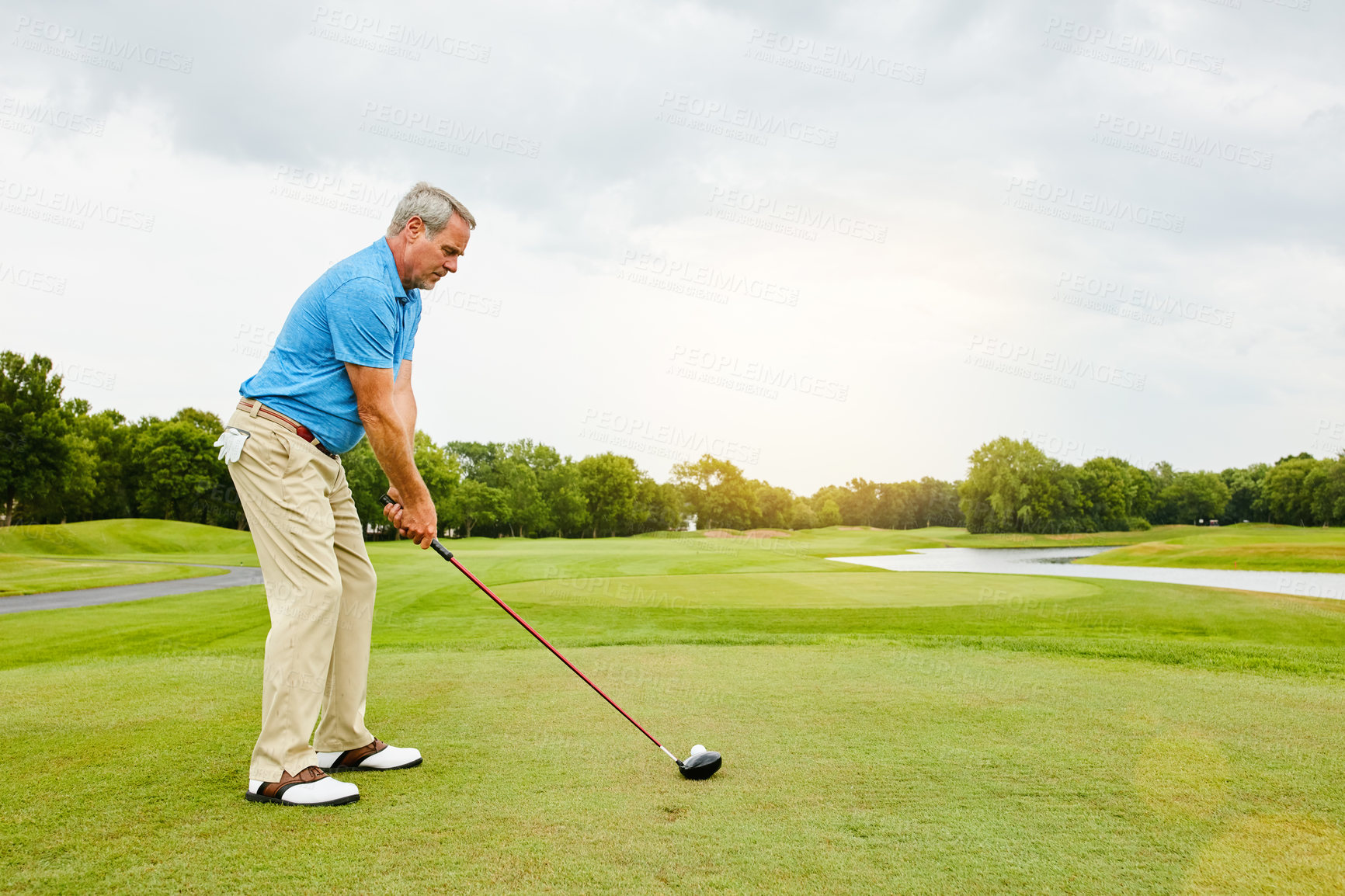 Buy stock photo Mature, man and swinging on field for golf or ball for improve balance, coordination and retirement leisure with relax. Golfer, club and play on lawn for physical activity, mobility and outdoor sport