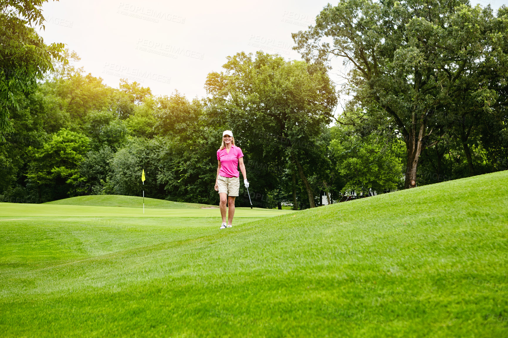 Buy stock photo Mature woman, happy and walking at golf course for sports talent or professional skill and training. Hobby, activity and smile at club for tournament, competition and game on fitness or practice