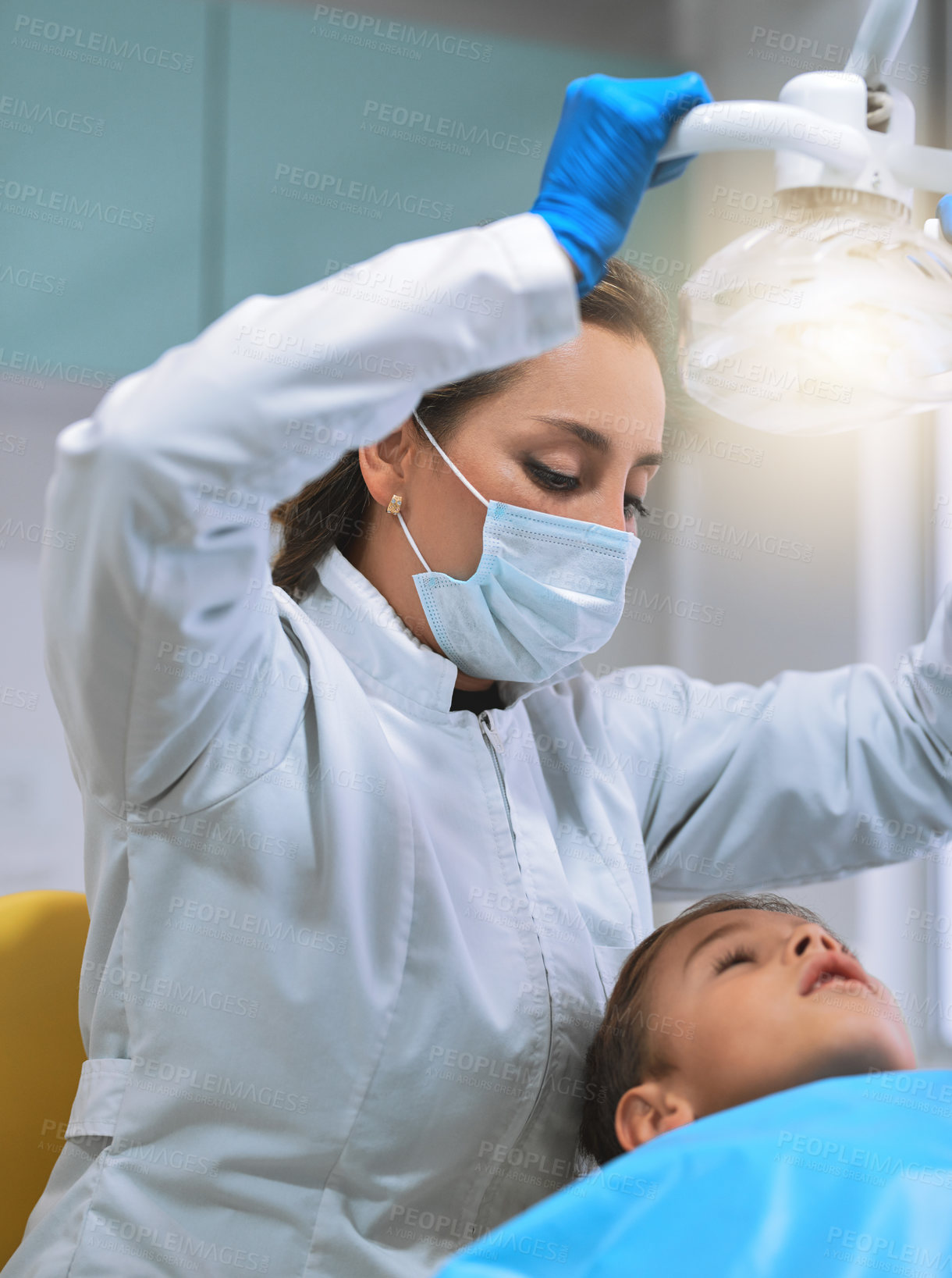 Buy stock photo Woman, dentist and protective mask with child in hospital for procedure preparation in oral care clinic. Female person, patient and examination as hygienist for teeth cleaning or root canal treatment