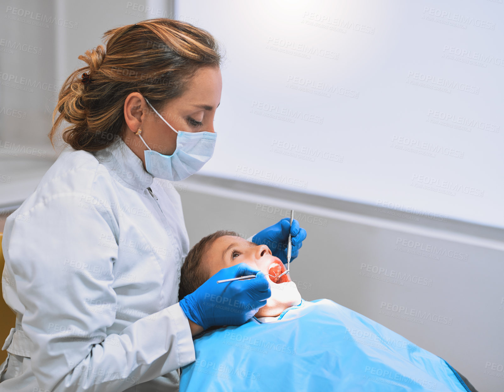 Buy stock photo Child, dentist and consultation for checkup in oral care for procedure or examination in clinic. Woman, patient and mask with tools as hygienist for teeth cleaning or root canal treatment in hospital