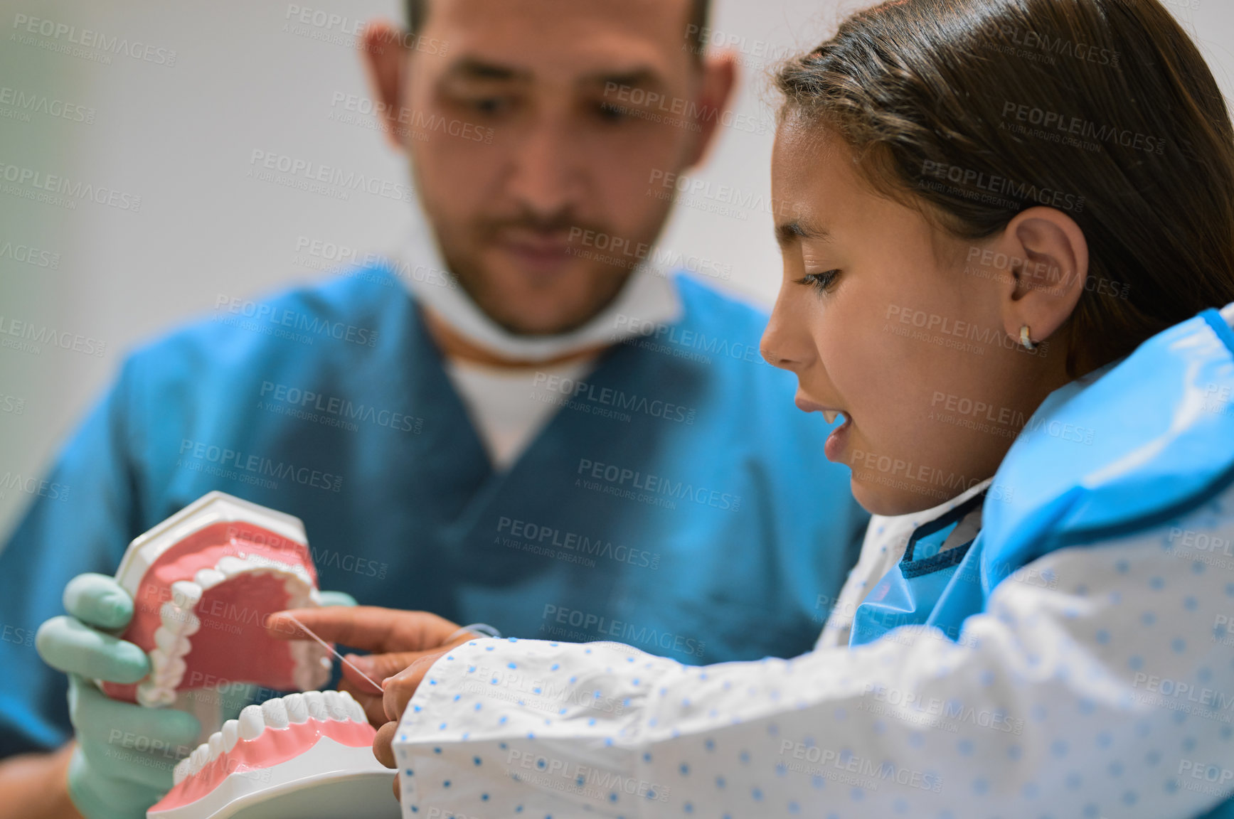 Buy stock photo Dentist, child and floss teeth model for hygiene education, dental learning or oral cleaning demonstration. Man, girl and orthodontist teaching routine, interactive lesson and mouth care advice