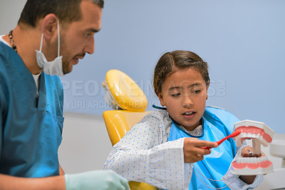 Buy stock photo Child, dentist and consultation for checkup in oral care with toothbrush in examination or clinic. Man, patient and help with tools as hygienist for teeth cleaning or root canal treatment in hospital