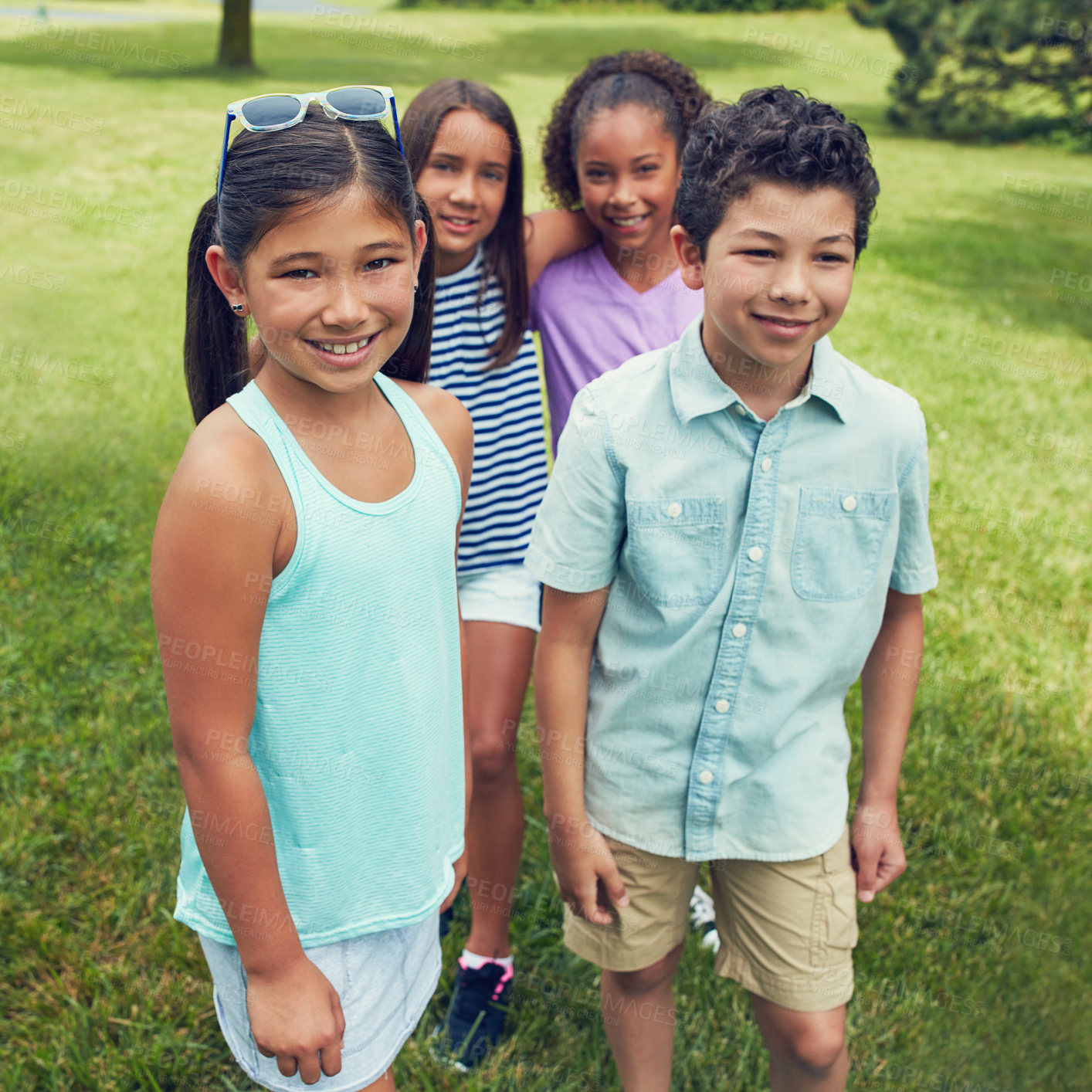 Buy stock photo Shot of a group of young friends hanging out together in the park