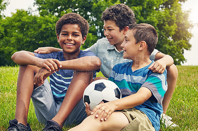 Buy stock photo Shot of a group of young boys out for a game of soccer in the park
