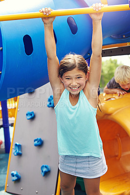 Buy stock photo Shot of a young girl playing on a jungle gym in the park