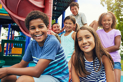 Buy stock photo Shot of a group of young friends hanging out together at a playground