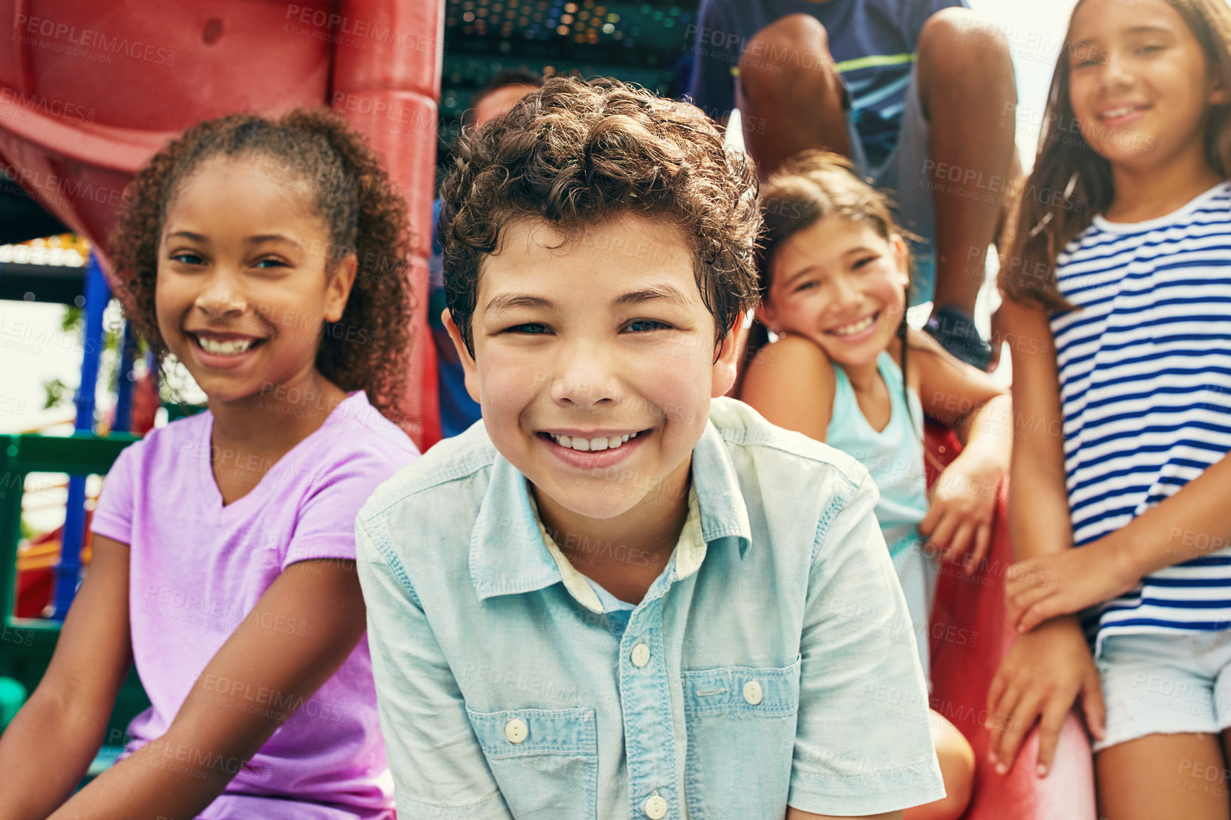 Buy stock photo Shot of a group of young friends hanging out together at a playground