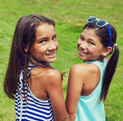 Buy stock photo Shot of two young friends hanging out together in the park