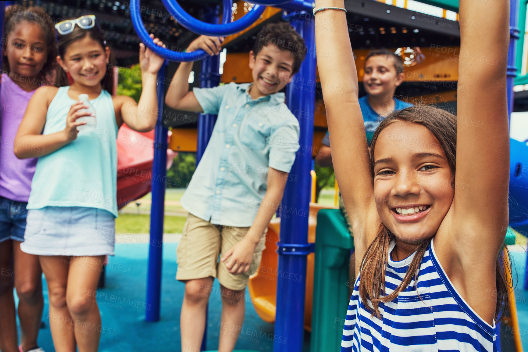 Buy stock photo Shot of a group of young friends hanging out together at a playground