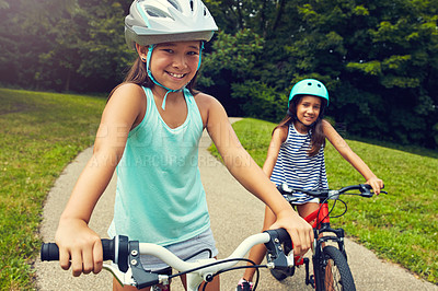 Buy stock photo Outdoor, portrait and children with bicycle for riding, learning and playing together with helmet for safety. Park, path and  happy girls for cycling, bike activity and coordination with balance