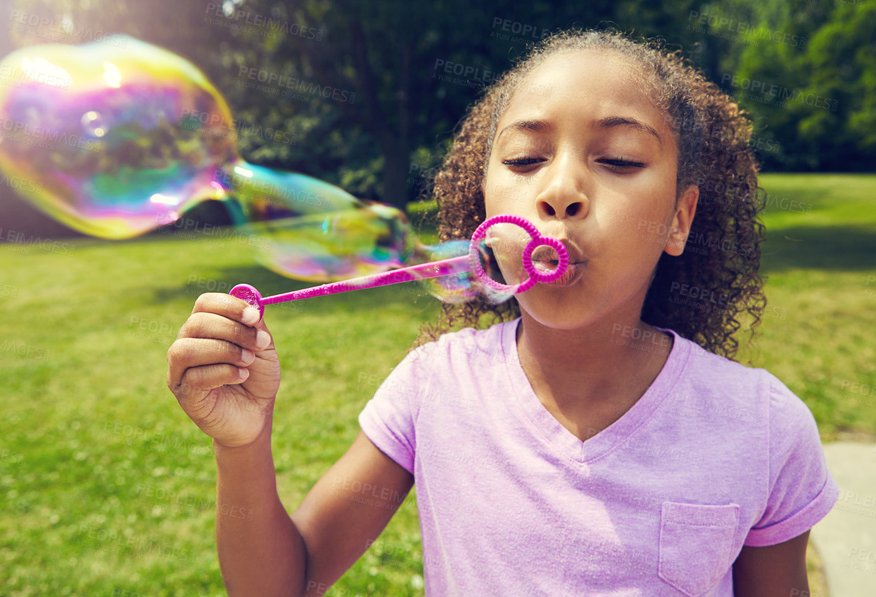 Buy stock photo Children, toys and girl blowing bubbles in park for fun, learning and freedom, vacation or games in nature.  Soap, wand and kid in a forest with foam magic, hobby or weekend, entertainment and travel