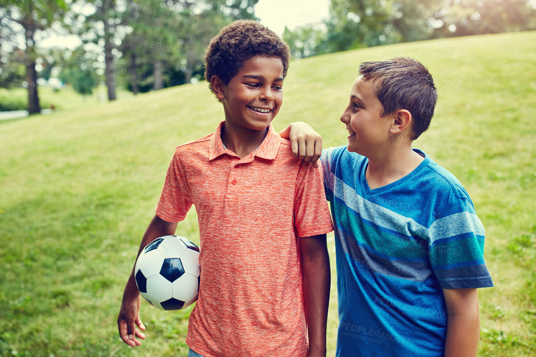 Buy stock photo Soccer ball, friends and children in park with smile, bonding and games on outdoor holiday together. Sports, nature and happy kids on grass with support, fun and diversity on summer camp for football