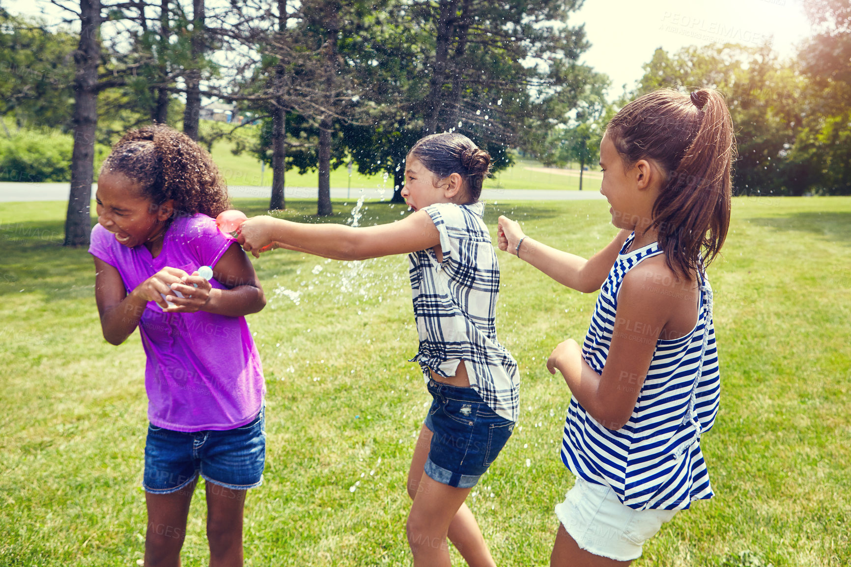 Buy stock photo Water, balloon and girl children in backyard with game, bonding and outdoor holiday together in garden. Playing, kids and happy friends on grass with fun, energy and splash on summer vacation in park