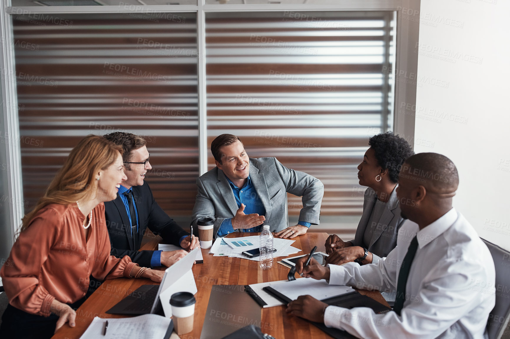 Buy stock photo Shot of a group of businesspeople having a meeting in an office