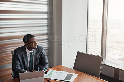 Buy stock photo High angle shot of a handsome businessman looking thoughtful while working in his corporate office