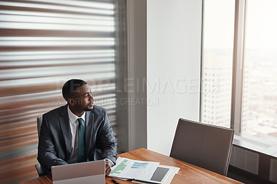 Buy stock photo High angle shot of a handsome businessman looking thoughtful while working in his corporate office
