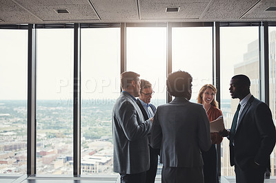 Buy stock photo High angle shot of a group of corporate businesspeople meeting in their boardroom