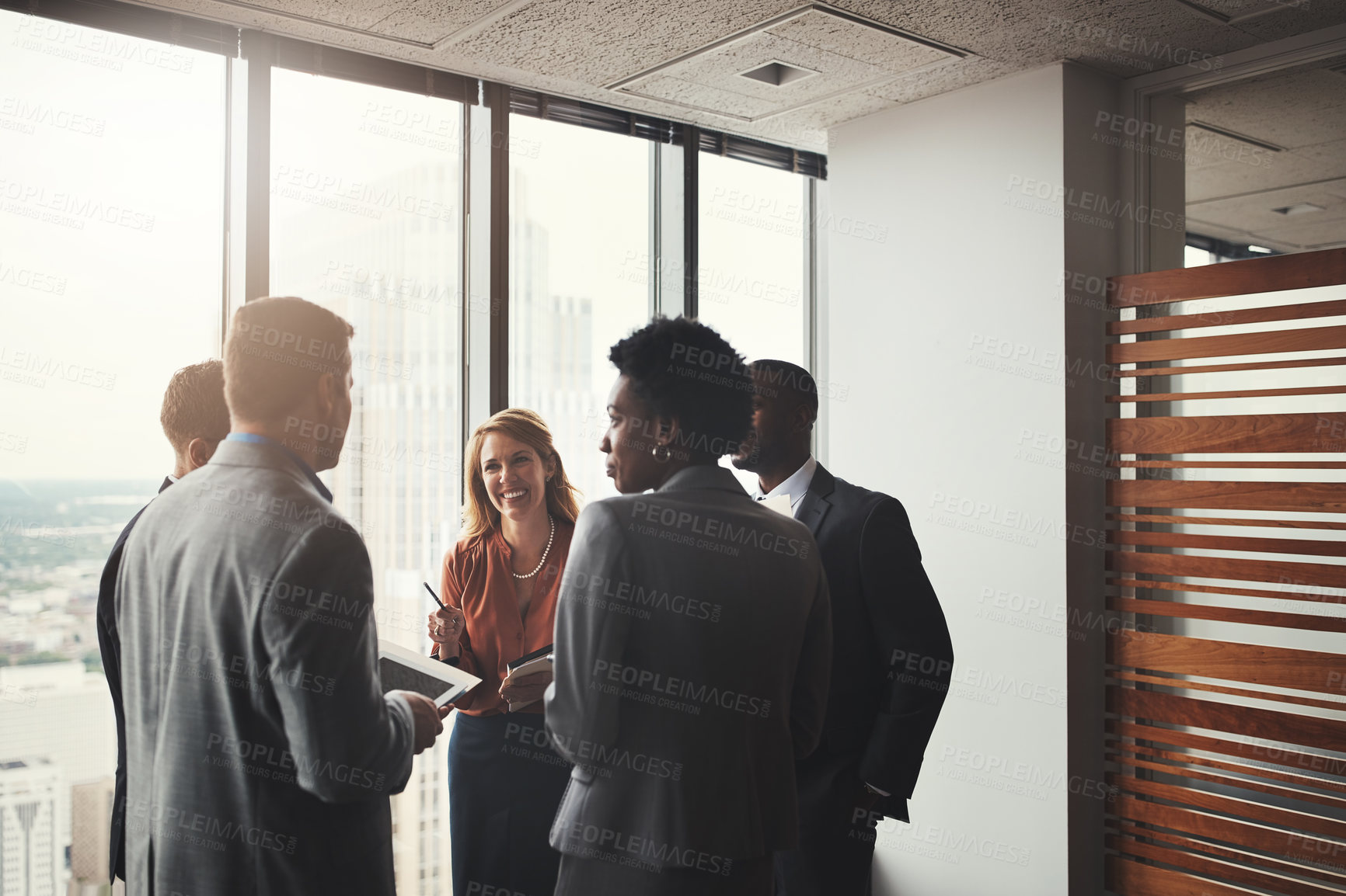 Buy stock photo High angle shot of a group of corporate businesspeople meeting in their boardroom