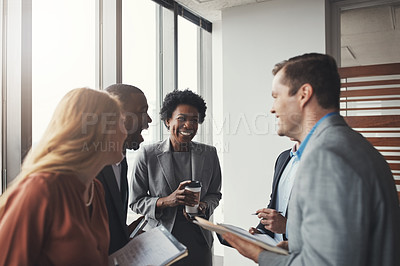 Buy stock photo High angle shot of a group of corporate businesspeople laughing during a meeting in their boardroom